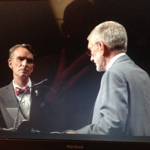 Bill Nye listens carefully as Ken Ham makes the claim that the Bible is a better source of fact than material science